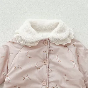 Close-up of baby girl winter floral cotton coat collar with white sherpa and lace trim.