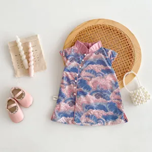 Detail view of the elegant pink and blue wave pattern baby girl qipao dress closeup.