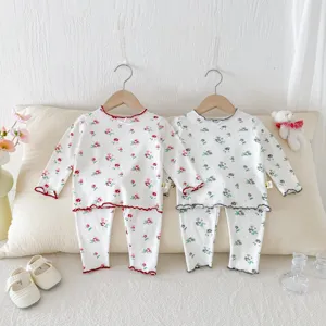 Close-up detail of children's floral pajama set, long sleeve top and pants, cozy fabric.