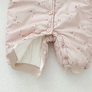 Detailed view of baby winter romper, thickened quilted warm jumpsuit with floral print, soft lining.