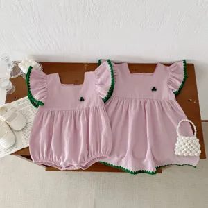 Cute baby girl summer romper and dress set, pink cotton with green crochet trim details.