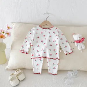 Children floral pajamas set detail view, cute long sleeve top and pants for kids home wear.