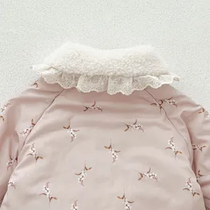 Close-up detail of baby winter padded jacket collar, pink floral print with cozy fleece trim.