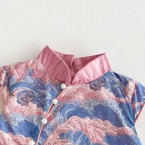 Girls qipao dress detail close up, pink mandarin collar with pearl buttons, wave print fabric.