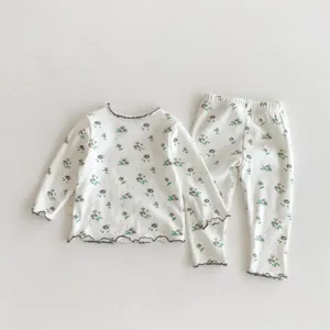 Cozy floral children's sleepwear set detail, long sleeve top and matching lounge pants.
