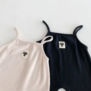 Cute baby ribbed romper detail, featuring lovely cat patch, soft fabric close-up view.