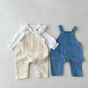 Cute baby girl overall set with ruffled collar shirt and denim overalls, soft cotton fabric.