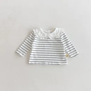 Detailed view of baby striped long-sleeve t-shirt with cute white ruffled doll collar.