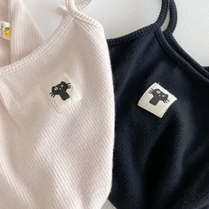 Ribbed baby romper detail showcasing cute cat patch design and soft fabric texture.