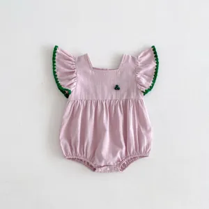 Pink baby girl romper detail, ruffled green trim sleeves and cute berry embroidery.