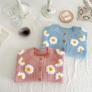Baby knit cardigan detail, cute daisy embroidery, toddler long sleeve sweater flatlay.