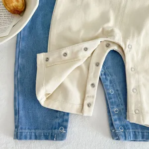 Infant baby cotton denim trousers detail shot highlighting metal snap buttons close view.