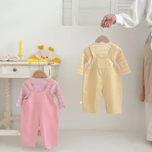 Toddler baby clothing set details, cute striped long sleeve top with solid color overalls.