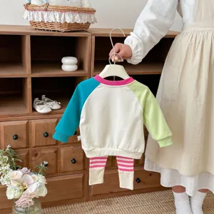 Detailed view of toddler colorblock sweatshirt and striped leggings set, soft knit fabric.