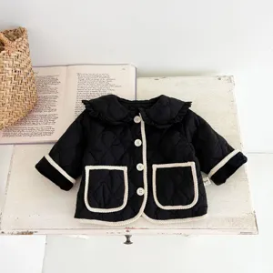 Chic quilted baby coat featuring classic contrast trim and cozy design for winter.