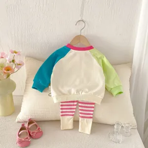 Baby girl spring knitwear set featuring loose color-blocked sweatshirt and elastic leggings.