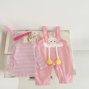 Detail shot of the cute toddler girl pink striped top and rabbit overalls set featuring playful design.