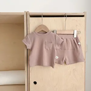 Detailed view of kids ribbed short sleeve t-shirt and shorts set in soft dusty pink.