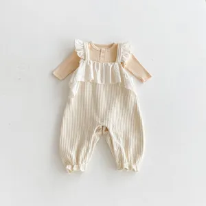 Infant cotton ribbed ruffle strap romper detailed shot, soft fabric and delicate button trim.