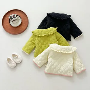 Detailed view of cute baby padded jacket with quilted pattern, ruffle collar, soft winter wear.