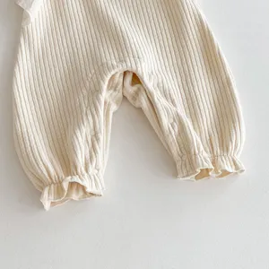 Infant ribbed cotton romper detail, soft texture and cute ruffles for baby girls daily wear.