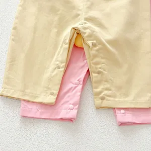 Close-up detail view of baby cotton romper snap button closure, soft infant clothing.