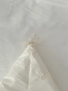 Nahaufnahme Detail von niedlichem Baby Winter Kapuzen Strampler mit Herz Stickerei Schleife.