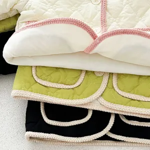 Detailed view of quilted baby fleece-lined padded jacket featuring sweet crochet trim details.