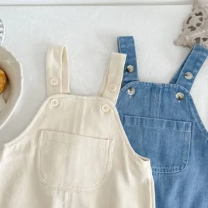 Detailed shot of cute infant cotton and denim overalls set in neutral colors for toddler daily wear.