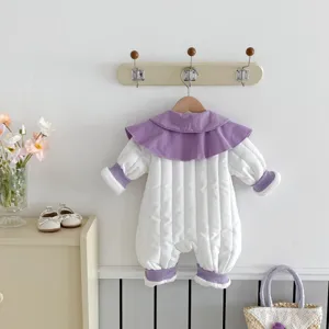 Detailed view of cute baby winter padded romper with purple collar hanging nicely on wall hook.