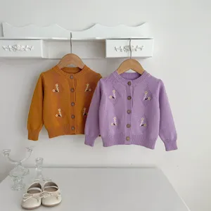 Baby knitted cardigan detail, cute floral embroidery and classic single-breasted design.