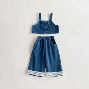 Girls denim crop top and wide-leg pants set with cute bows and white lace trim detail.