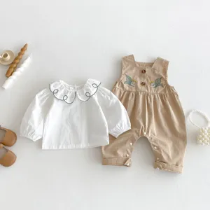 Cute baby girl clothing set with white long sleeve blouse and khaki embroidered romper, perfect for spring.