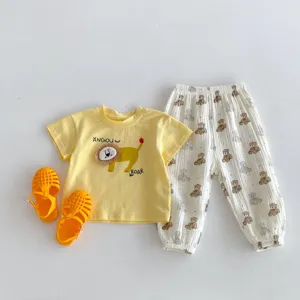 Detailed view of infant summer clothing set, cute lion print t-shirt and bear pants.