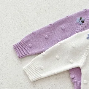 Infant baby cotton knit sweater detail shot with cute hand embroidery and textured popcorn dots.