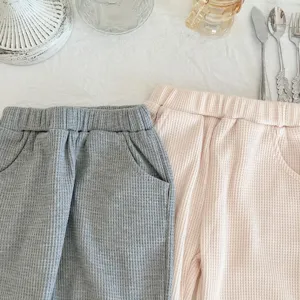 Toddler waffle knit casual pants detail view, elastic waist and pockets in grey and pink.