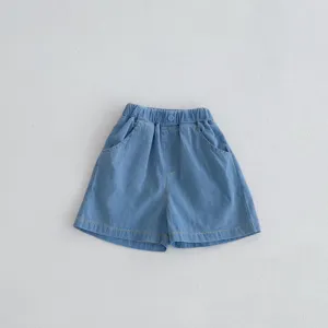 Soft light blue denim shorts detail view, elastic waistband, comfortable fabric for kids.
