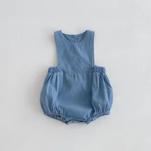 Soft blue denim bubble romper detail, showing elastic waistband and neat stitching.