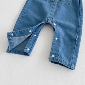 Infant denim baby romper detail shot showing convenient crotch snap buttons and blue fabric.