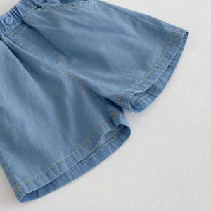 Lightweight baby denim shorts detail view, soft blue fabric, elastic waist, cute stitching.