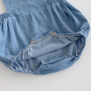 Infant baby soft denim romper detail, light blue breathable fabric with convenient snap buttons.