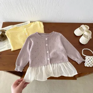 Close-up of toddler knit cardigan detail showing cute hollow-out pattern and chiffon hem.
