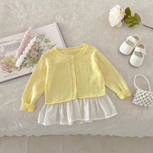 Detailed view of baby toddler girl yellow knitted cardigan with white chiffon hem cute summer top.