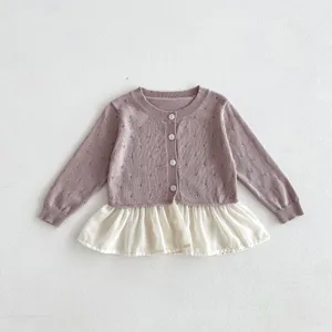 Detailed view of toddler girl knit cardigan, hollow pattern, button front, ruffle hem detail.