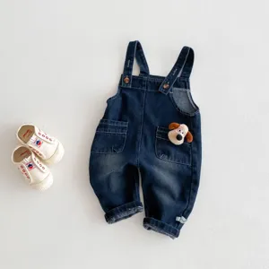 Vue détaillée de la salopette en denim pour bébé avec poche peluche chiot et chaussures.