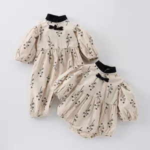 Infant baby girl Chinese style romper detail, featuring mandarin collar and floral print.