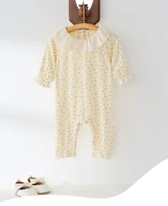 Floral baby romper detail with cute ruffled collar and long sleeves for infant girl daily wear.
