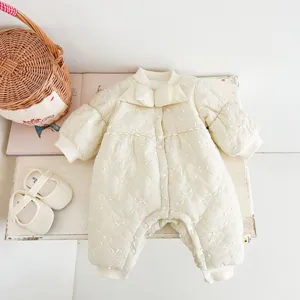 Detail shot of cute baby winter romper, quilted fleece-lined crawling suit with bow collar.