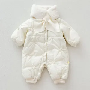 Detailed view of baby winter padded romper in cream white with plush collar and cute knit bow.