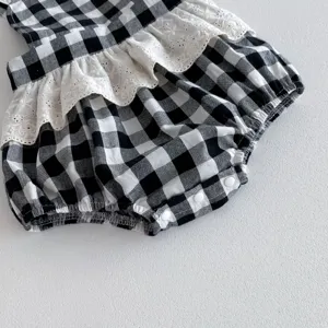 Baby girl black white plaid romper detail view, sweet lace ruffle trim and snap closure soft.